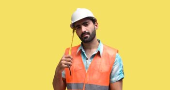 maintenance worker in hard hat and orange vest