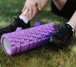 close-up of man's sneekers in grass next to roller