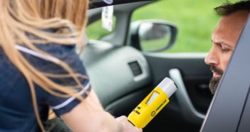 breathalyzer test on man in car