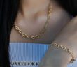 close-up of woman with gold necklace and bracelet