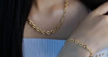 close-up of woman with gold necklace and bracelet