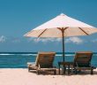 umbrella and chairs on the beach overlooking the water