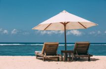 umbrella and chairs on the beach overlooking the water