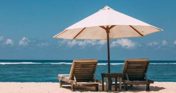umbrella and chairs on the beach overlooking the water