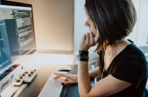 side view of woman working at computer