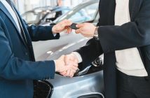 handing over car keys and shaking hands