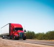 red and white semi truck on the road
