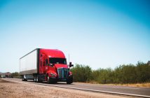 red and white semi truck on the road