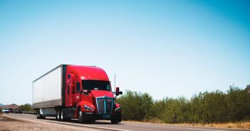 red and white semi truck on the road