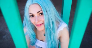 pretty woman in white top with blue hair