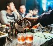 close-up of bartender hand pouring a cocktail