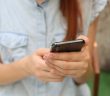close-up of phone in hands of woman
