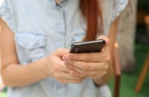 close-up of phone in hands of woman