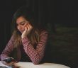 pretty brunette woman holding smartphone