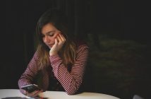 pretty brunette woman holding smartphone