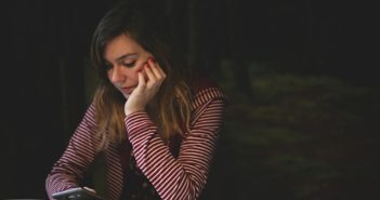 pretty brunette woman holding smartphone