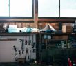 A man relaxing in a home garage workshop on a weekend afternoon