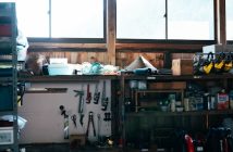 A man relaxing in a home garage workshop on a weekend afternoon