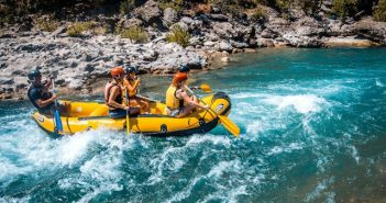 four people in raft on river