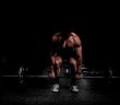 muscular man deadlifting weights