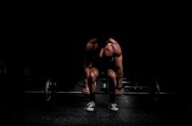 muscular man deadlifting weights