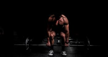 muscular man deadlifting weights