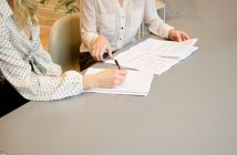 close-up of female attorney with female client at table