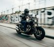 man in helmet riding motorcycle at high speed
