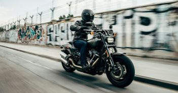 man in helmet riding motorcycle at high speed