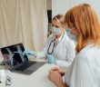 doctors reviewing x-ray on laptop