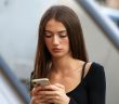 attractive brunette woman using smartphone