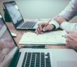 accountants working with paper and laptops