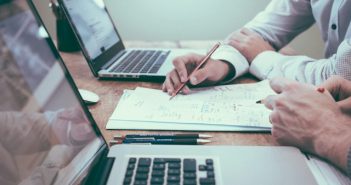 accountants working with paper and laptops